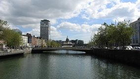 The River Liffey  in Dublin City Centre with buildings and bridge in the background. 
