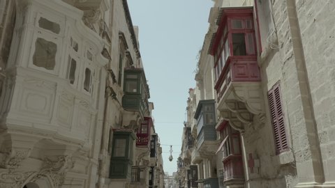 Drone flying throught beautiful old street,Valletta,Malta . Old, vintage windows, balconies. - 4K