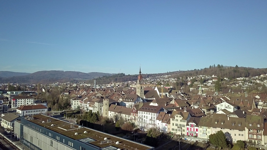 Aerial View Zofingen small city in Switzerland with historic church and old town buildings and Swiss Alps in the backdrop. Concept: architecture, history, tourism, cityscape, medieval town, church