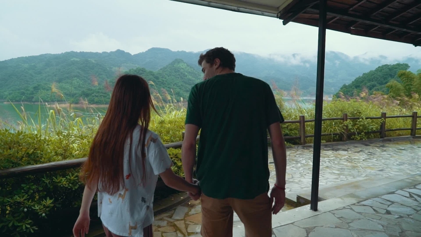 Young couple exploring the beautiful outdoors in mountain lake setting. millennial lovers on vacation