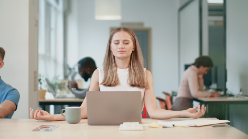 Business woman relaxing after work in office. Exhausted woman making yoga breath at coworking. Upset woman trying to concentrate with meditation at open space office.