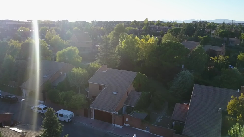 Aerial footage view from the drone of a neighborhood with its swimming pools inside a forest in the outskirts of Madrid city. Amazing lifestyle in the residential areas of Madrid with green areas