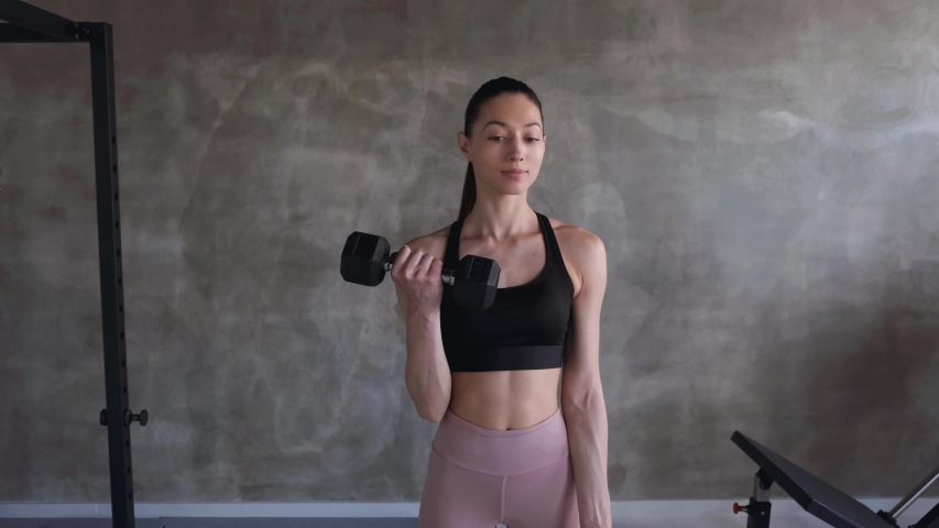 fit girl working out and lifting weights at the gym