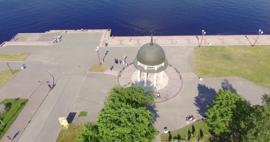 Aerial soaring around rotunda over lake embankment