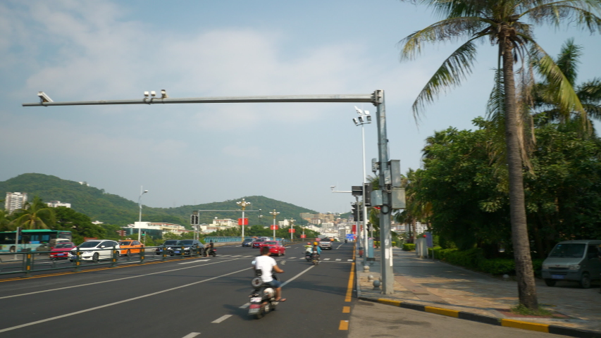 sanya city center sunset sunny day traffic street panorama 4k hainan china