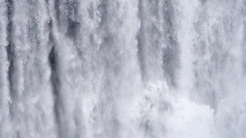 Waterfall close up slow motion background, Skogafoss Iceland. Abstract water background. Shot of real water texture for compositing, motion graphics, or background.