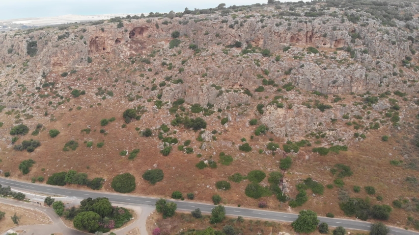The slopes of Mount Carmel with rich vegetation and caves. View from the drone. Northern Israel.