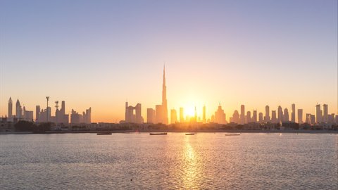 4K Time lapse - Urban Skyline and modern skyscrapers in Dubai UAE at sunrise.