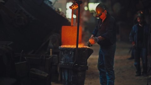 Hard work in the foundry. Molten metal pouring, metallurgy, steel casting foundry