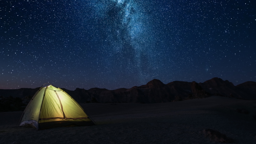 Adventure romance night time and meeting dawn in a tourist tent on a starry night high in the mountains before dawn Royalty-Free Stock Footage #1031875091