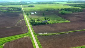 Breathtaking rural agricultural aerial hyperlapse with fast moving clouds and shadows sweeping across the landscape.