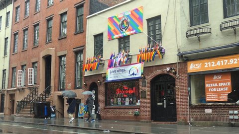 New York, New York / USA - June 10 2019: the Stonewall Inn, Christopher Street on a rainy day, across from the Stonewall National Monument, Greenwich Village, Manhattan.