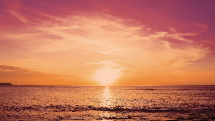 Red sundown sea. The coast of the Caribbean Sea, the yellow sun touches the horizon, beautiful orange clouds around the sun. Amazing view from the beach to the red sundown sea. Beautiful sea landscape | Shutterstock HD Video #1031884796