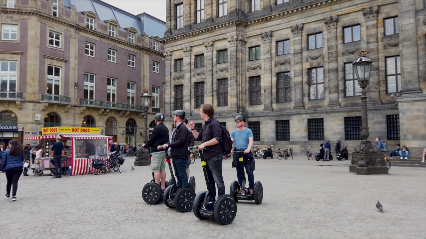 Amsterdam / Holland: 06 13 2019: Group of Men Travel with Segways in Amsterdam