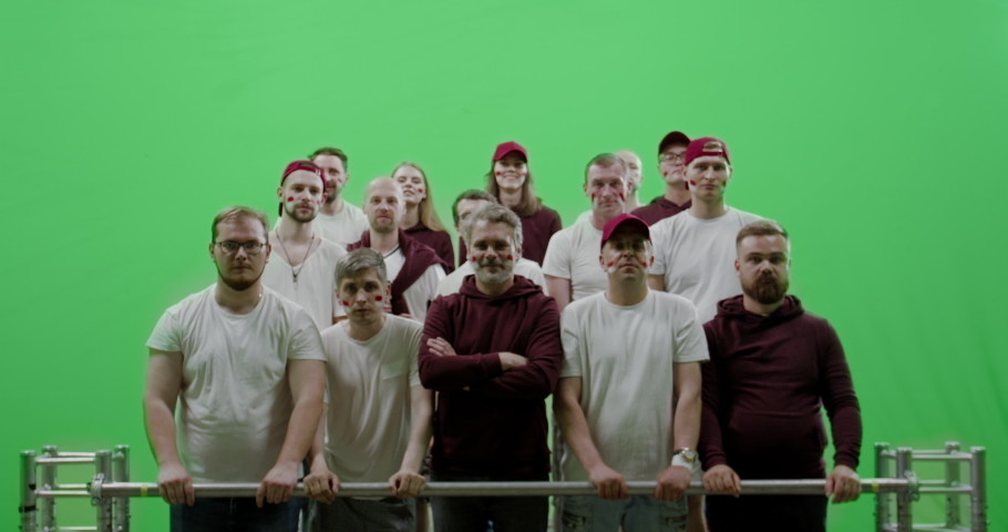 GREEN SCREEN CHROMA KEY Front view group of people fans wearing red clothes watching a sport event. 4K UHD ProRes 422 HQ