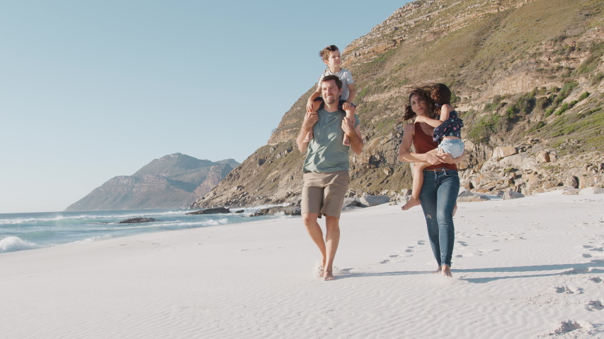 Family Walking Along Beautiful Sandy Beach On Summer Vacation Royalty-Free Stock Footage #1031905469