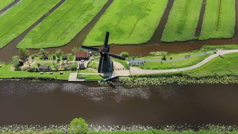 Aerial view of historic windmill in Kinderdijk village, famous Dutch tourist destination and UNESCO World Heritage Site - South Holland, Netherlands, landscape panorama of Europe from above