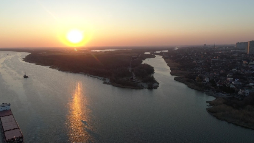 Aerial shooting over the river and the ship, overlooking the railway bridge evening sunset footage