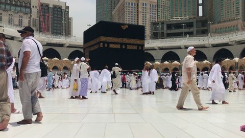 MECCA, SAUDI ARABIA - CIRCA MAY 2019 : Muslim pilgrims circumambulate and touch the Kaabah cloth (kiswah or kiswa) in Makkah, Saudi Arabia.