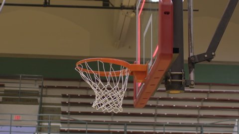 Closeup low angle of a basketball making a basket for three points