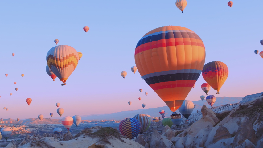 hot-air balloons flying over the mountain landsape of Cappadocia,Turkey. Royalty-Free Stock Footage #1031910785