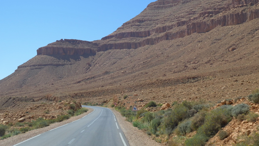 View of Middle Atlas Mountain range in slow motion while travelling to Erfoud from Ifran in Morocco