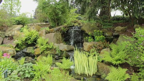 View of waterfalls at the park/botanical garden - vertical pan