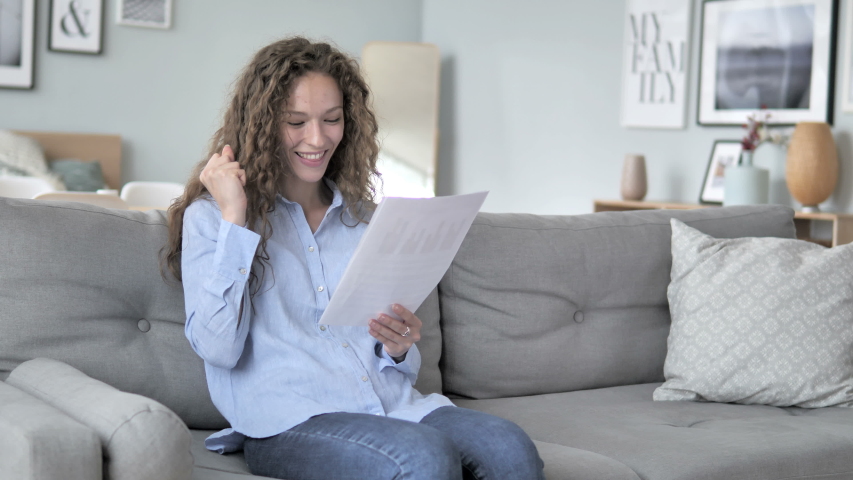 Excited Curly Hair Woman Cheering while Reading New Contract | Shutterstock HD Video #1031918024