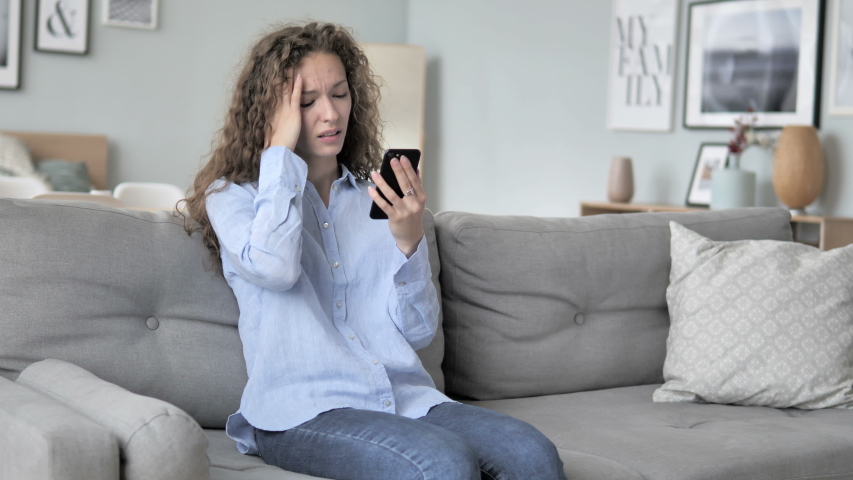 Curly Hair Woman in Shock by Loss while Using Phone | Shutterstock HD Video #1031918120