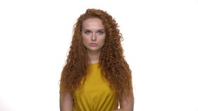 Displeased young redhead curly woman feeling sad with crossed hands while looking at the camera over white background isolated