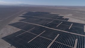 Aerial footage. Solar Energy Farm at Atacama Desert, Chile. Thousands modules rows passed on a reverse flight along the Solar Energy PV Plant an amazing scene from an aerial drone point of view 5/8