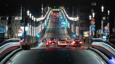 Timelapse shot of an up-to-date highway with illuminated streets and dashing cars and trucks in Brussels at night in summer