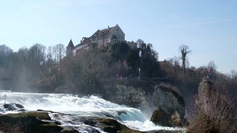 4k Rhine Falls Schaffhausen, Neuhausen. Europe's largest waterfall - By ship u can reach castles, the Falls Basin and even the rock in of the waterfall. View over the river to the castle.