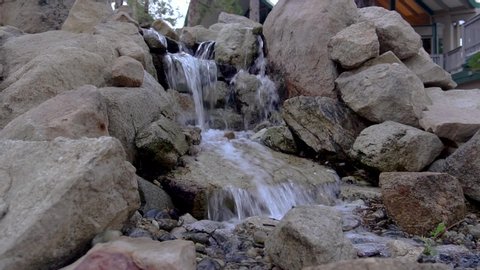Mini Waterfall or Stream with Water Flowing through Rocks