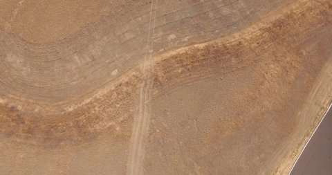 Aerial Drone Shot Revealing a Grand Stand and Parking Lot of a Raceway in the Desert.