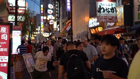 Osaka, Japan, June 17, 2019 : slow motion of tourists visiting Dotonbori at night. Dotonbori is most popular travel site in Osaka, Japan