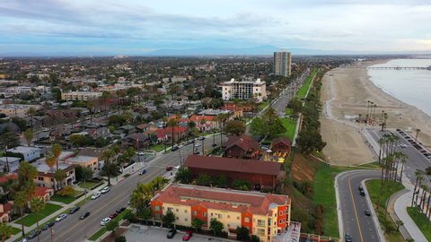 Aerial Forward: City By Ocean Shore With Blue Sky - Long Beach, California
