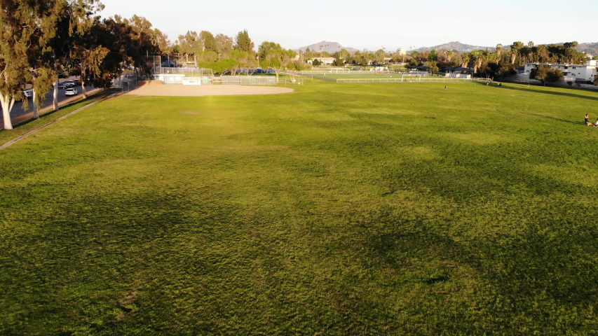 Aerial shot flying up and over baseball and soccer fields at a neighborhood park.