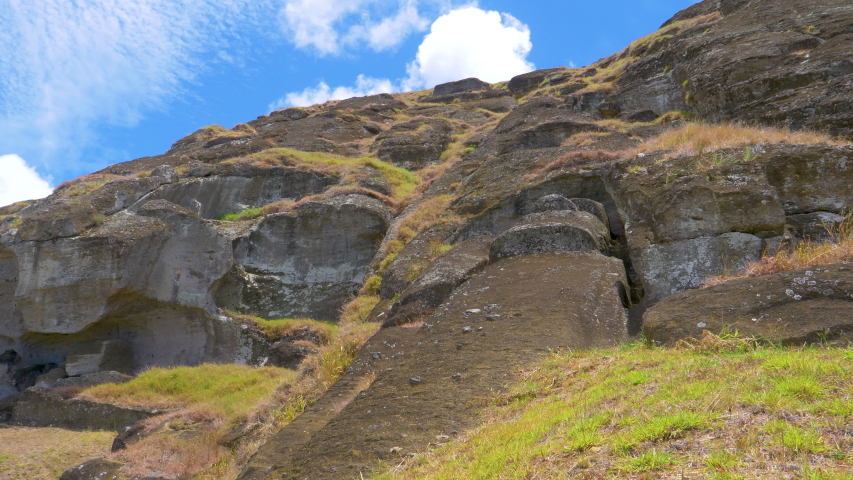 DRONE: Flying above unfinished El Gigante moai statue on sunny Easter Island. Spectacular view from above of a sculpture with human features made of volcanic matter left unerected on exotic island.
