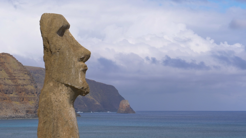 DRONE, COPY SPACE: Large volcanic sculpture with human features faces the deep blue ocean. Breathtaking view of a large mysterious moai sculpture on Easter Island. Beautiful traditional monument.