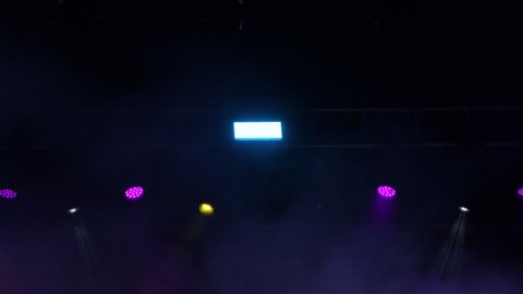 Stage lights moving with smoke fog in a concert