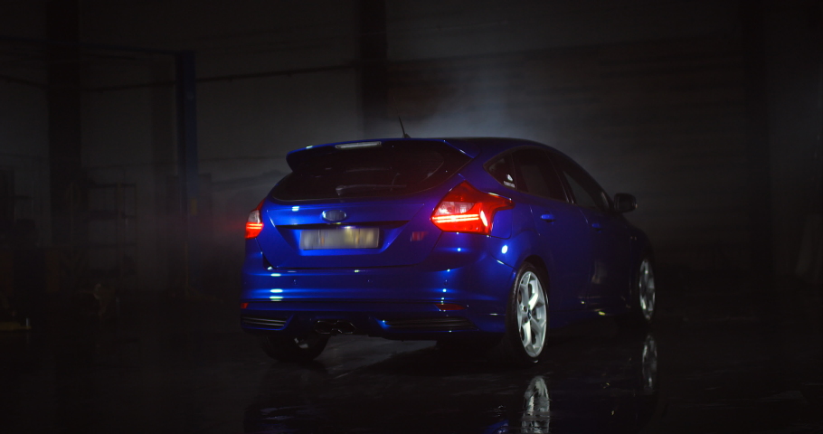 Metallic blue Line hatchback with blured logo.