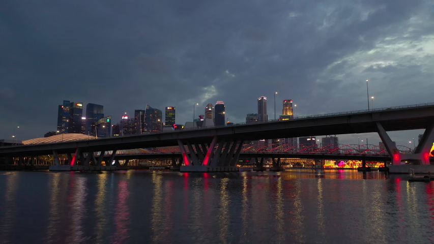 night illuminated singapore city downtown riverside traffic bridge aerial panorama 4k