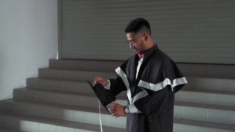 Indian Student Graduate in Robes Wearing a Square Academic Cap at University