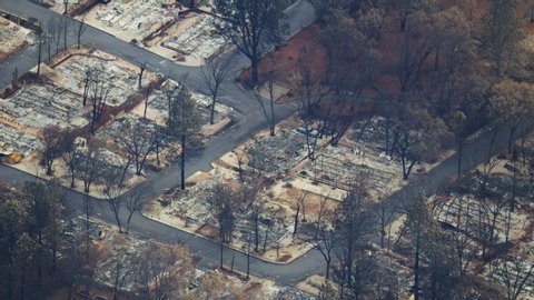 Aerial view of destructive forest wildfire which has laid waste to an entire town a community destroyed property and lives lost Paradise California America RED WEAPON