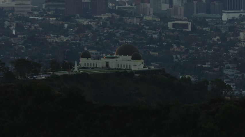 Aerial view central Los Angeles at sunrise from Mount Hollywood with Griffith Observatory overlooking urban neighborhood California USA