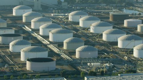 Aerial view Los Angeles oil reserves industrial fuel storage tanks and refinery pipelines in urban environment California USA