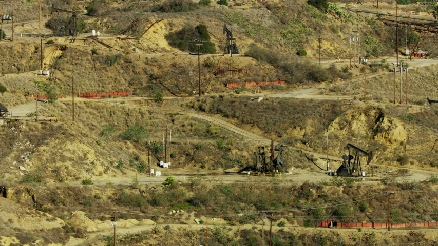 Aerial view Inglewood oil field Baldwin Hills with central Los Angeles cityscape and financial district skyline California USA