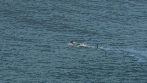 Aerial view of surfer and riding on water surface Pacific Ocean Mavericks Pillar Point Harbor California USA RED WEAPON