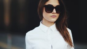 Close up, slow motion. Business woman with luggage after tiring flight. Portrait of attractive young woman smiling at beach removes sunglasses cool. Attractive blonde young girl with big full lips - Powered by Shutterstock - Get 15% off with code: PIKWIZARD15